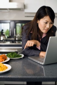 Businesswoman Working at Home During Dinner